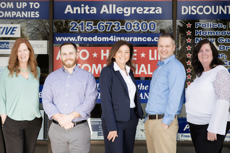 About Our Agency - Portrait of Freedom Insurance Group Team Members Standing Outside in Front of the Office Building